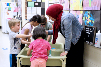 educator with children engaging in water sensory play