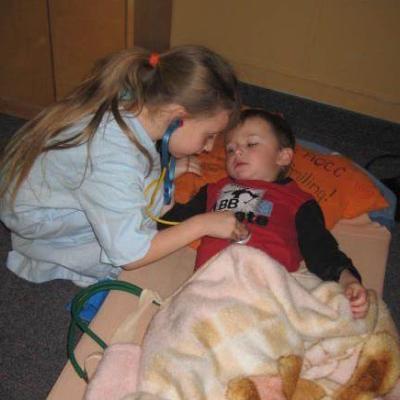 two children playing doctor and patient