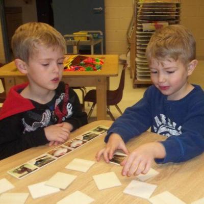 two young boys organizing photos