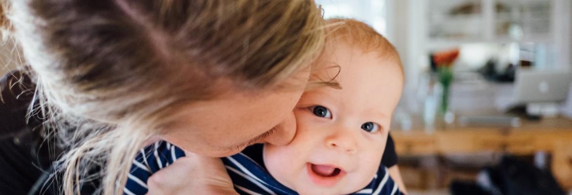 mother hugging and kissing baby